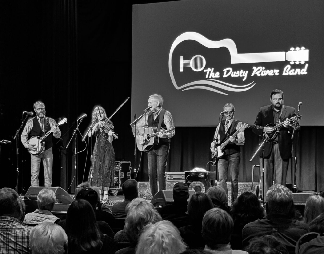 A group of people on stage playing guitar.