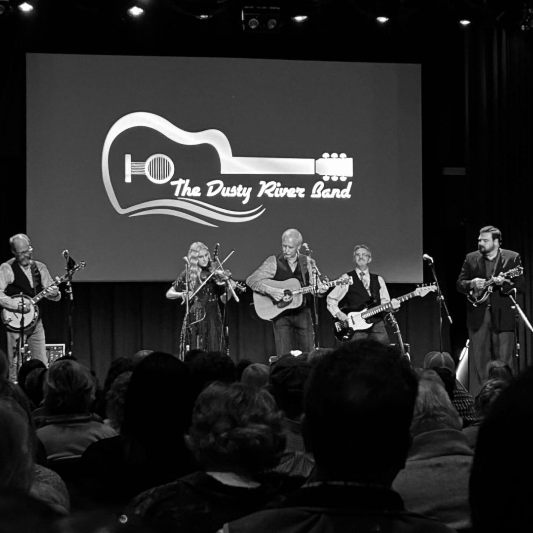 A group of people playing instruments on stage.